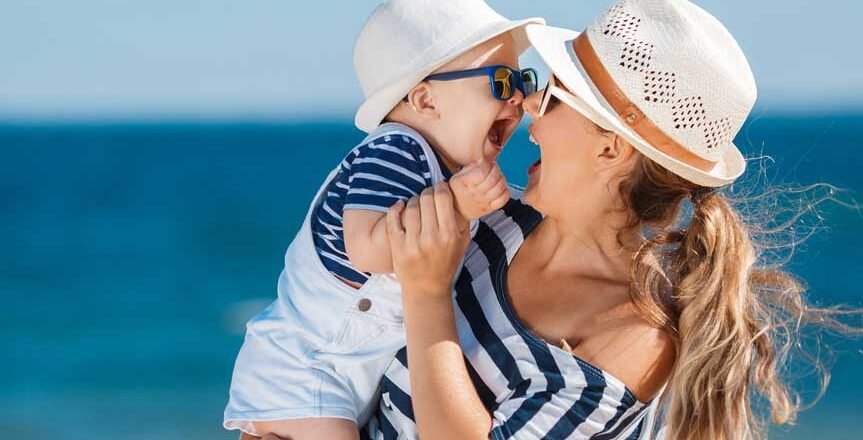 happy-mother-with-little-boy-having-fun-beach-near-sea.jpg